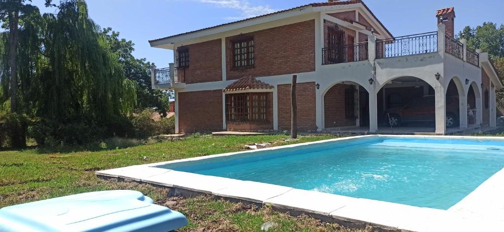 a house with a swimming pool in front of it at La Viajera in San Lorenzo