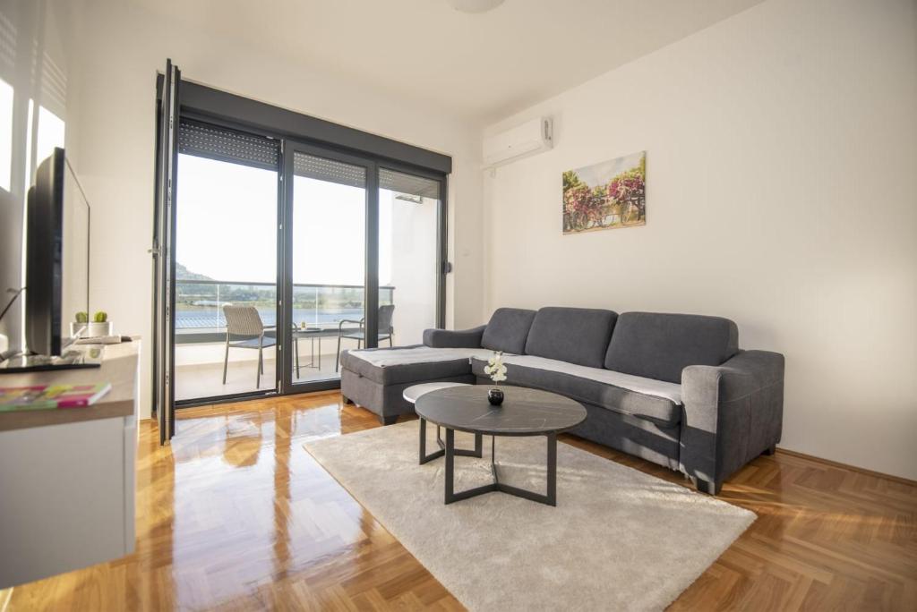 a living room with a couch and a table at APARTMAN DERETIC in Trebinje