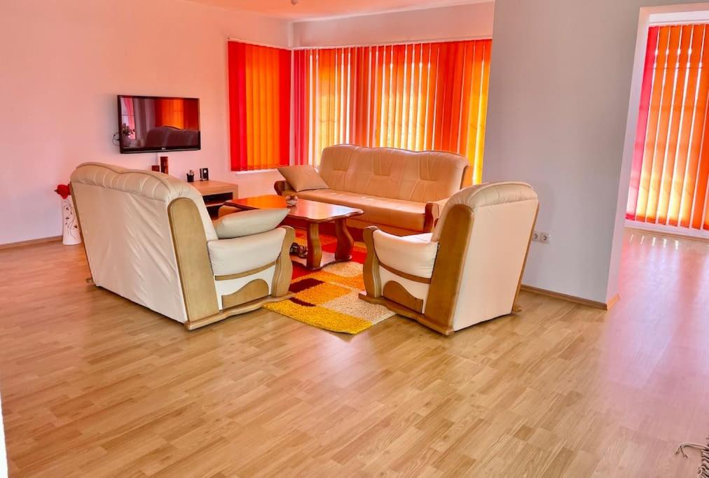 a living room with chairs and a table and a dining room at Villa Tesla S in Velika Kladuša