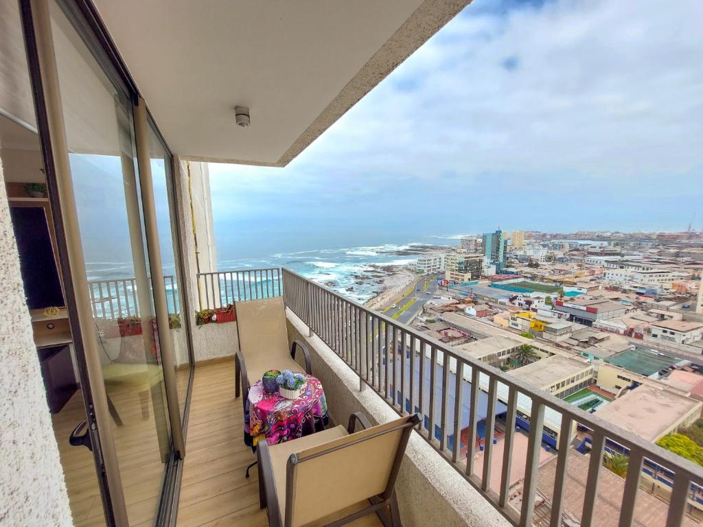 a balcony with a view of the ocean at Depto costa Iqq in Iquique