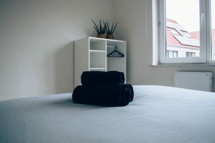 a black chair sitting on top of a bed at Vakantieappartement DE SPUIKOM in Ostend
