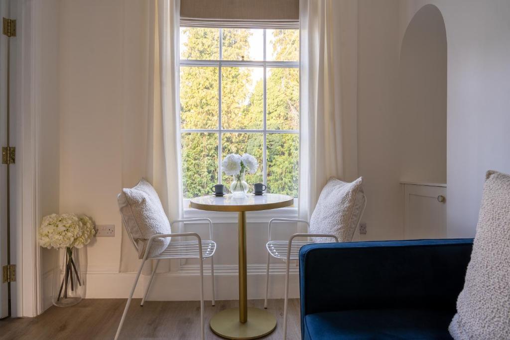 a living room with a table and a window at No 2 at Albion Terrace in Bath