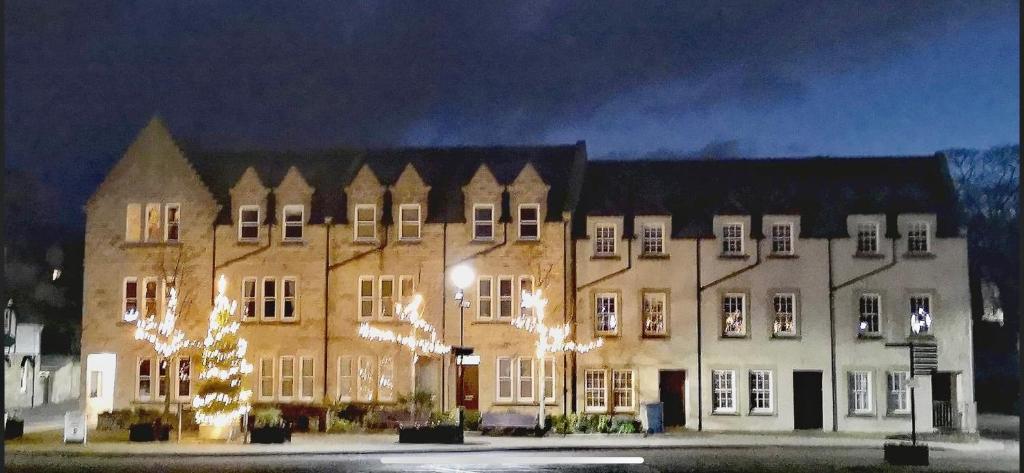 a large building with christmas lights in front of it at The Town House in Dornoch