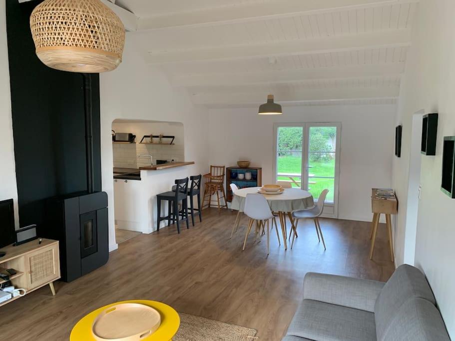 een woonkamer en een keuken met een tafel en stoelen bij Maison Noirmoutrine agréable de 3 chambres avec grand jardin in Le Grand Vieil