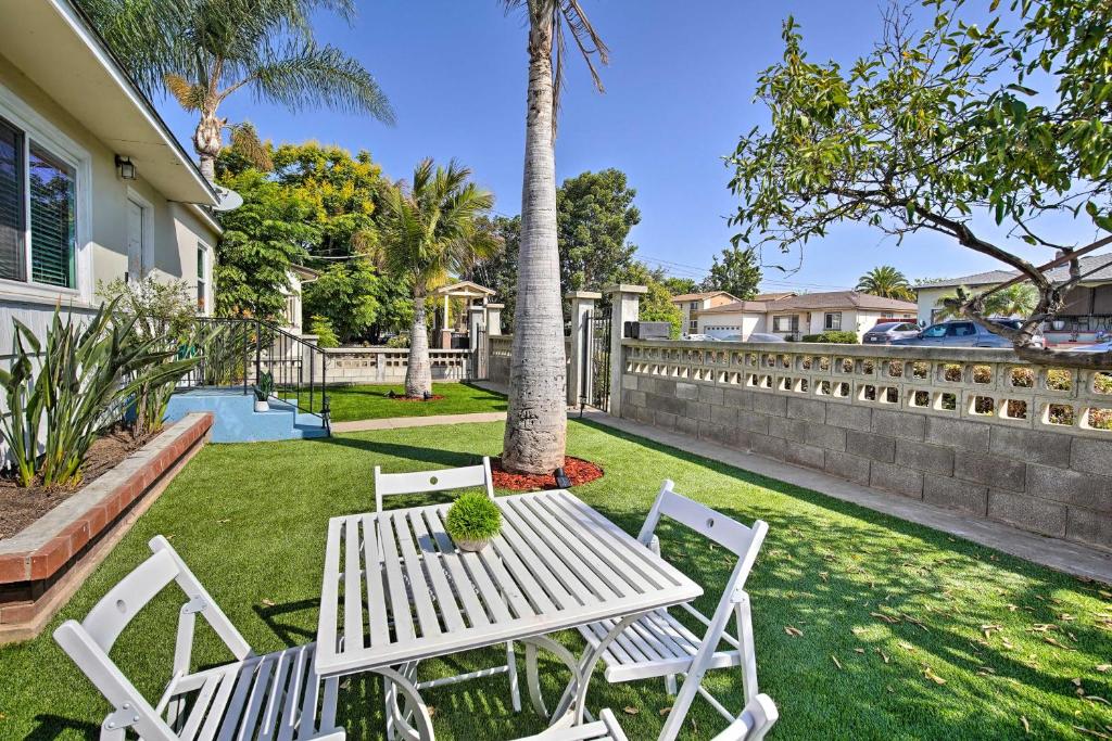 a white table and chairs in a yard with a palm tree at Contemporary 2 BR House w/ Yard, near Balboa & Downtown in National City