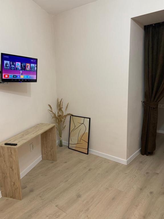 a living room with a tv on a wall at Comfort Home Soborna 283 in Rivne