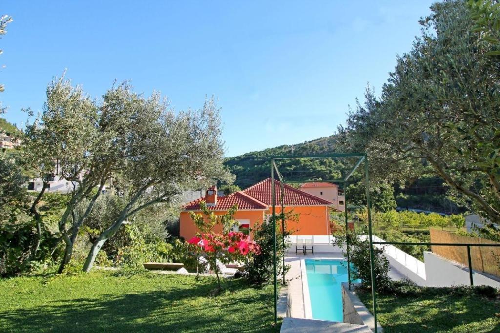 a villa with a swimming pool and a house at Villa Marietta Equino in Donje Sitno