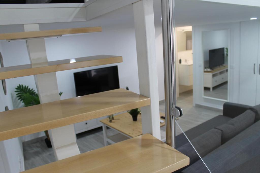 Televízia a/alebo spoločenská miestnosť v ubytovaní Apartamentos los Nidillos