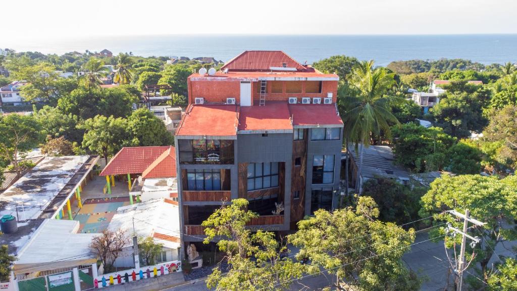 an overhead view of a building with the ocean in the background at Nopalero Suites Hostel in Puerto Escondido