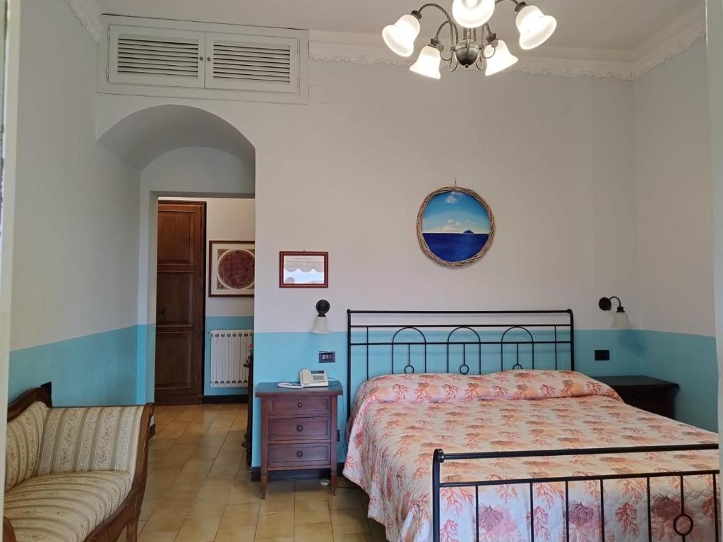 1 dormitorio con 1 cama y 1 sofá en Locanda Miranda, en Tellaro