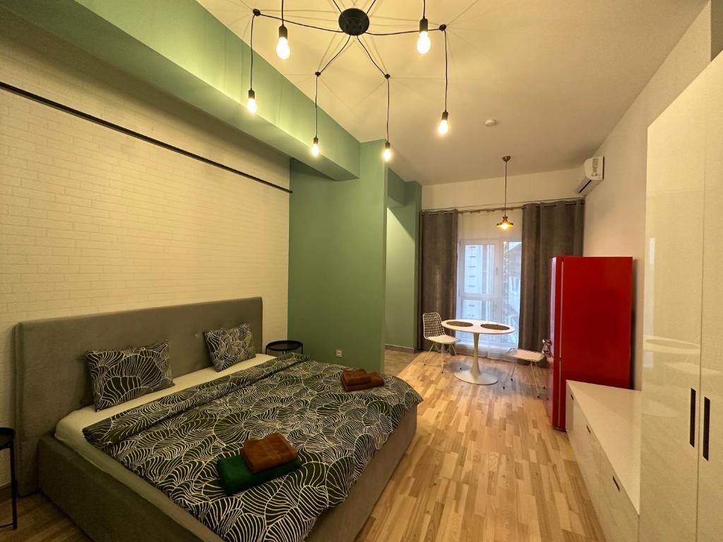 a bedroom with a large bed and a red cabinet at Industrial Touch - designed in Iaşi
