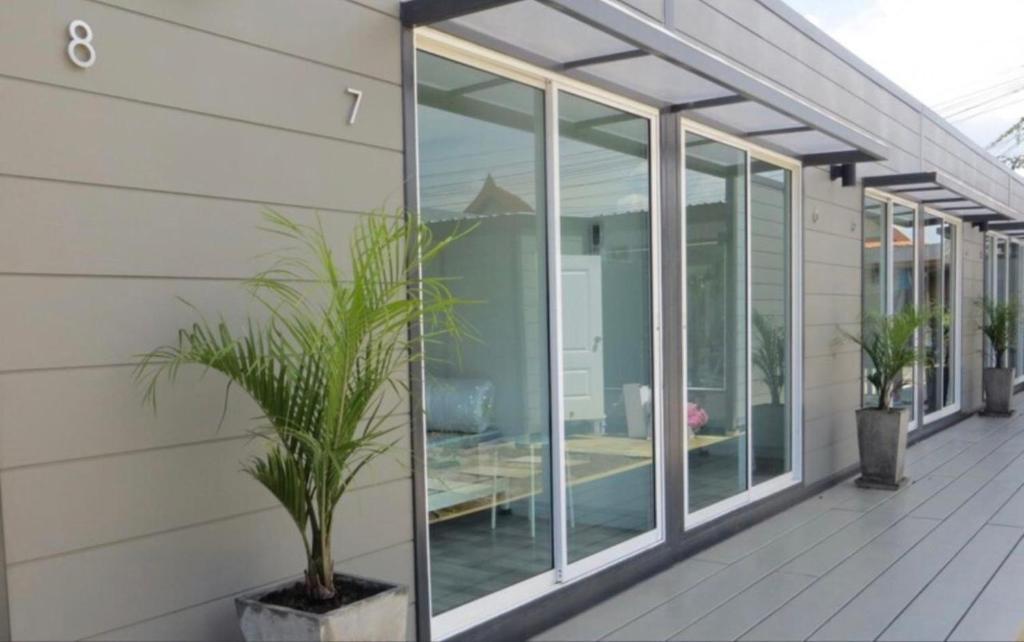 a house with glass windows and a potted plant at Non Du Lay Guesthouse in Ko Lanta