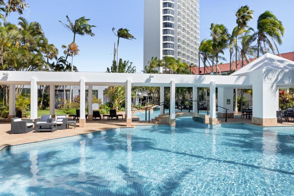 a swimming pool with a pavilion and a building at Crowne Plaza Surfers Paradise, an IHG Hotel in Gold Coast