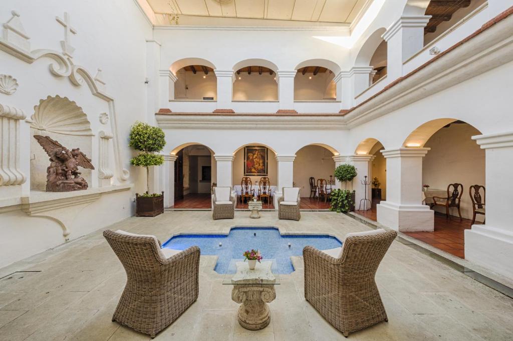 a large lobby with a pool in the middle of a building at Palacio Borghese Hotel Boutique - Adults Only in Oaxaca City