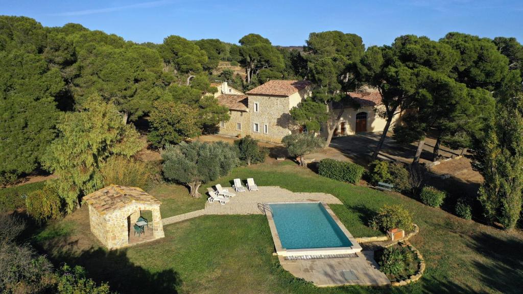 una vista aérea de una casa con piscina en Ancien Mas viticole à 10 min de Narbonne, en Bizanet