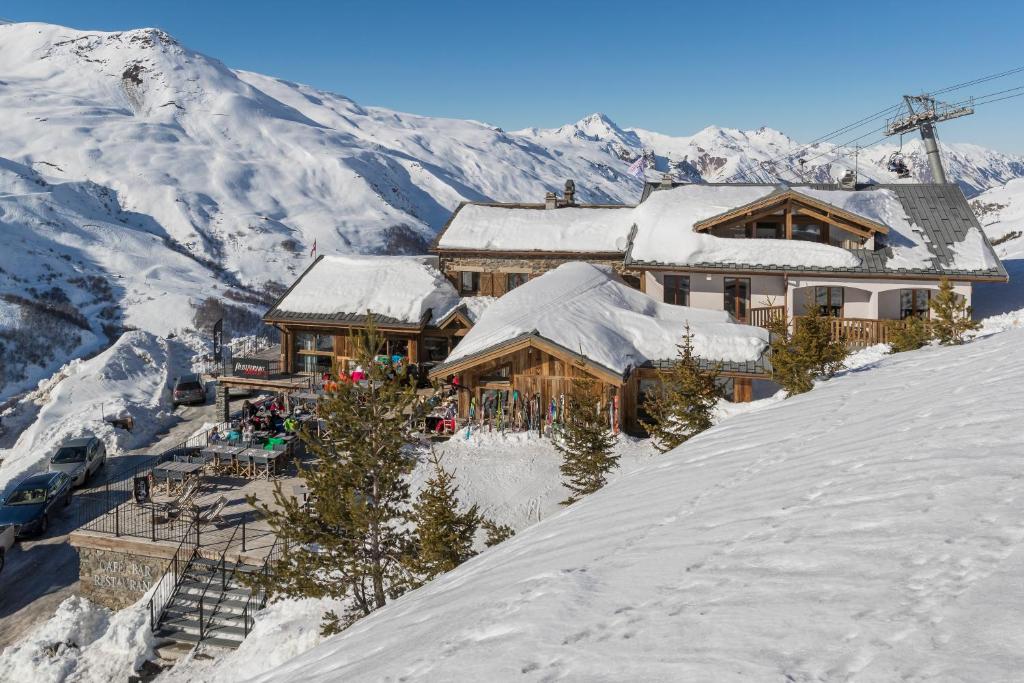 a ski lodge on top of a snow covered mountain at Hillary Hotel in Les Menuires