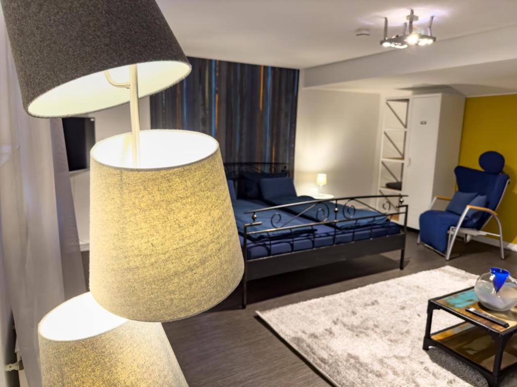salon z łóżkiem i lampką w obiekcie Apartelliment - smart übernachten in Köln w Kolonii