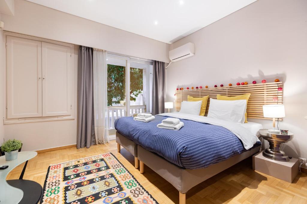 a bedroom with a large bed and a window at Bang in Kolonaki by Athenian Homes in Athens