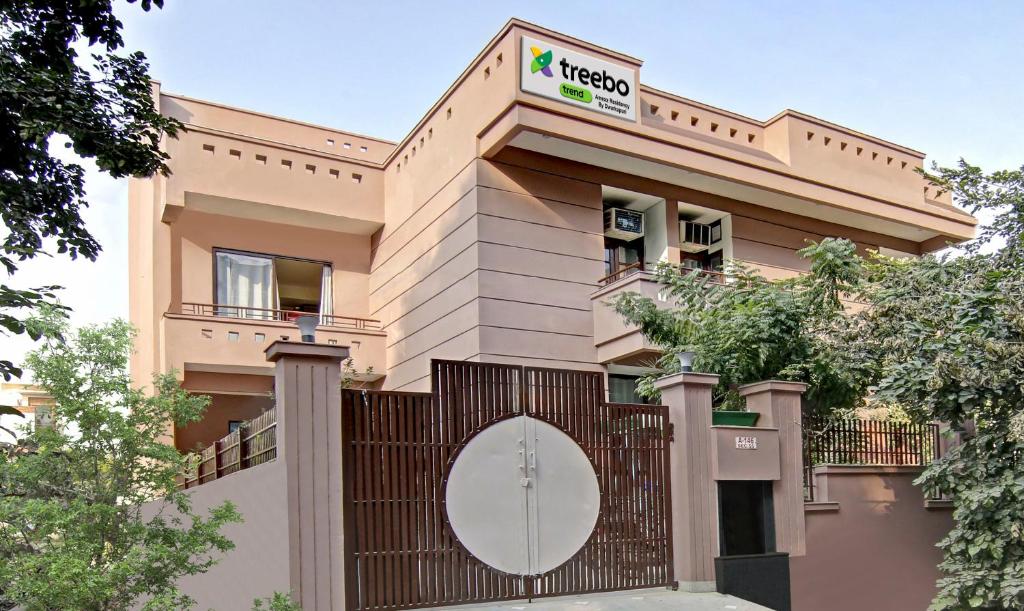 un edificio con una valla delante en Treebo Trend Amexx Golf Course Road, en Gurgaon