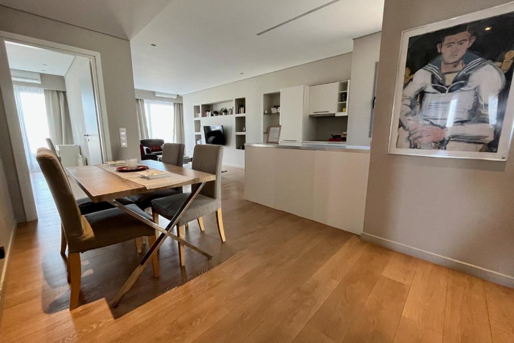 a dining room and kitchen with a table and chairs at Central Athens Loft in Athens