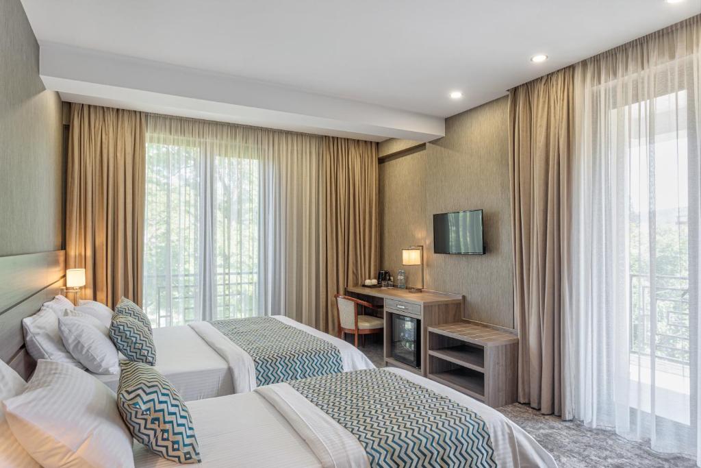 Postel nebo postele na pokoji v ubytování Vinum Hotel