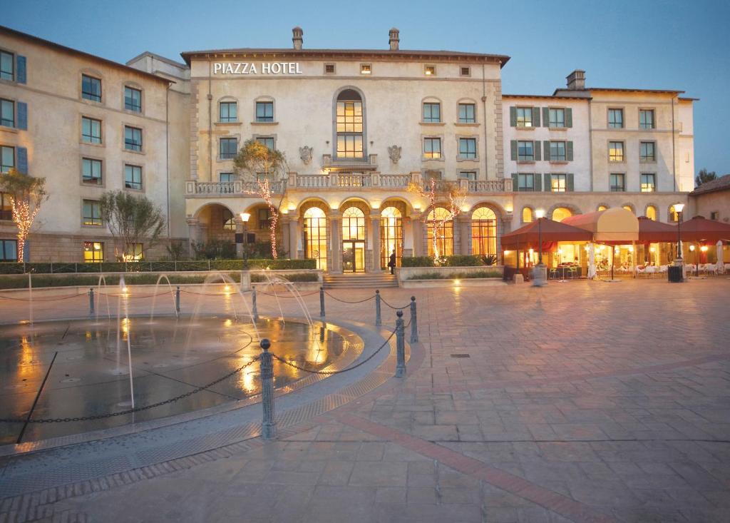 a large building with a fountain in the middle of it at Piazza Hotel Montecasino in Johannesburg