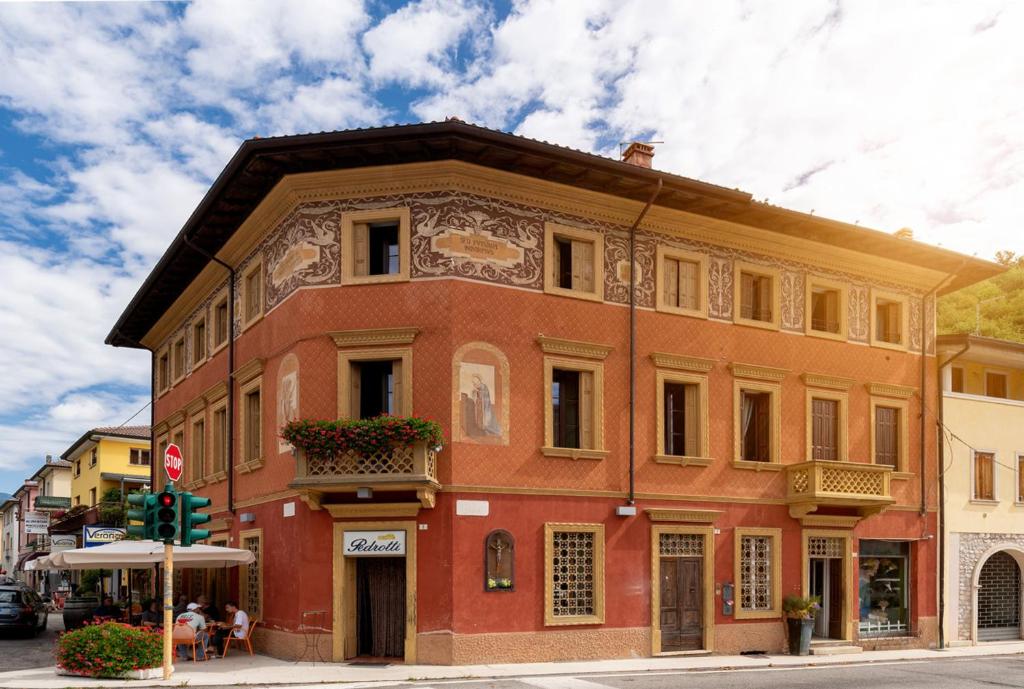 a red building on the corner of a street at Palazzo Fritz in Badia Calavena