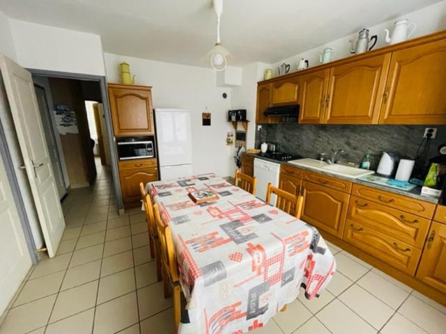 a kitchen with a table with a table cloth on it at IDEAL MONTAGNE in Le Mont-Dore