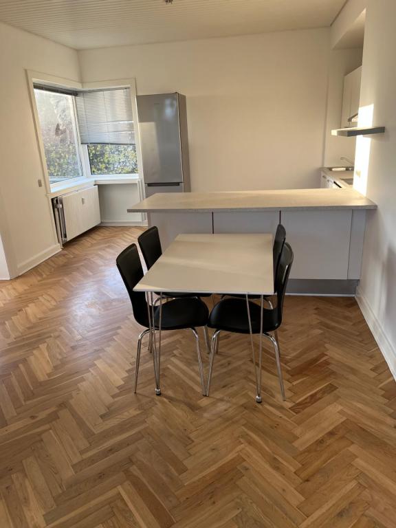 a kitchen with a table and chairs in a room at Great view apartments 1 in Aalborg