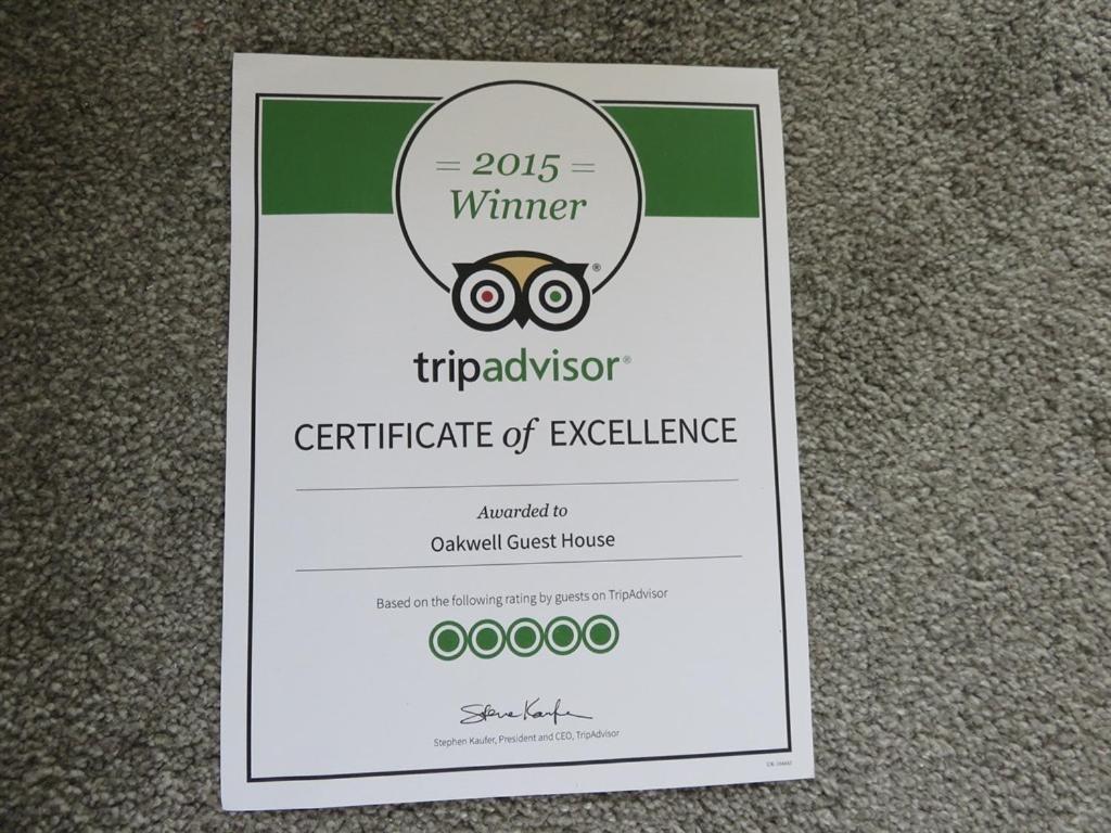 a sign with a certificate of excellence for at Oakwell Guest House in Bridlington