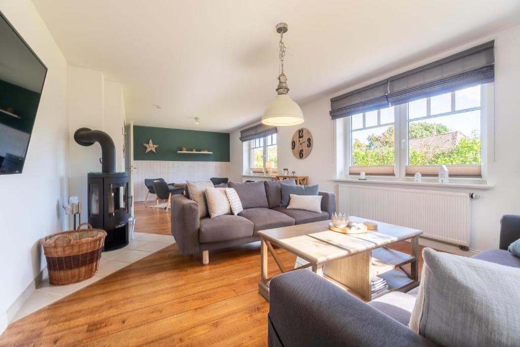 a living room with a couch and a table at Haus Perle in Oevenum