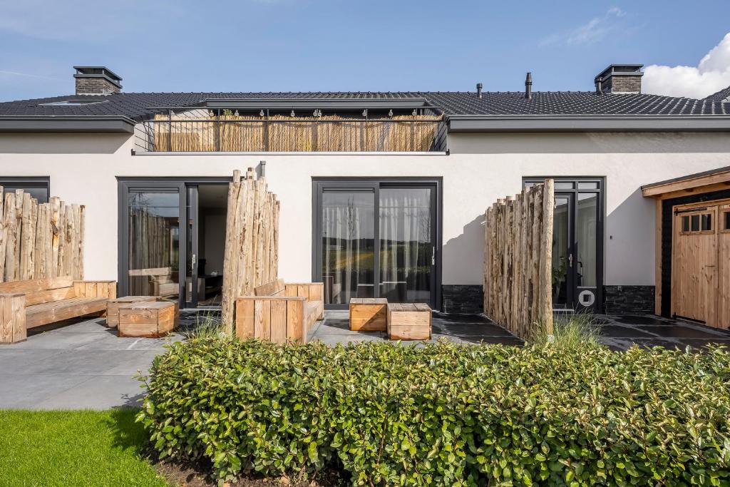 a house with large windows and wooden palettes at Holiday Apartment Strand in Noordwijk