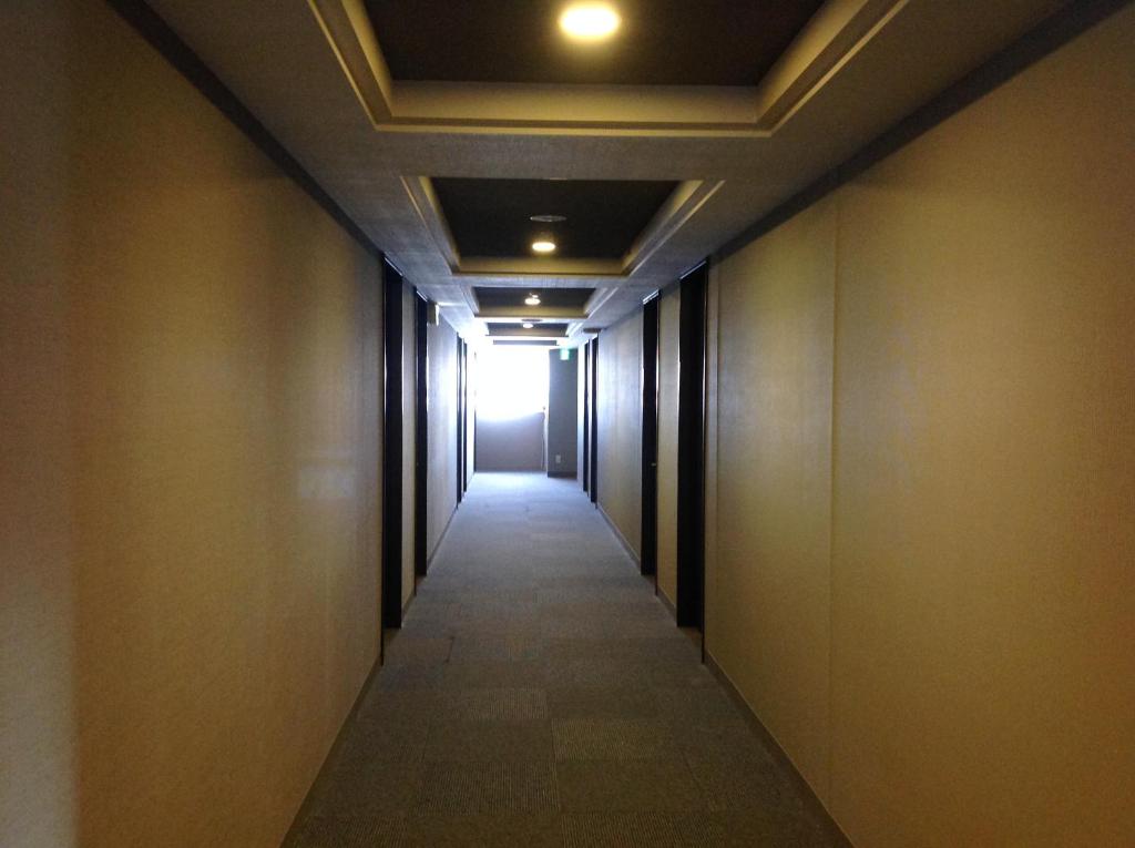 a corridor of an office building with a light at the end at Washington R&B Hotel Hachioji in Hachioji