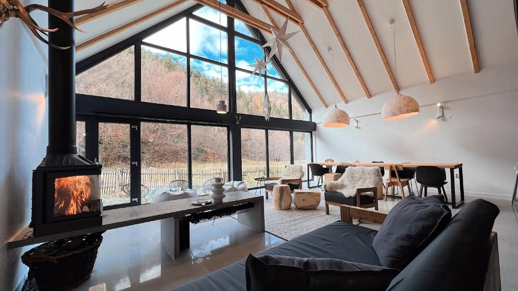 a living room with a fireplace and a large window at Cabana Sapte in Breaza