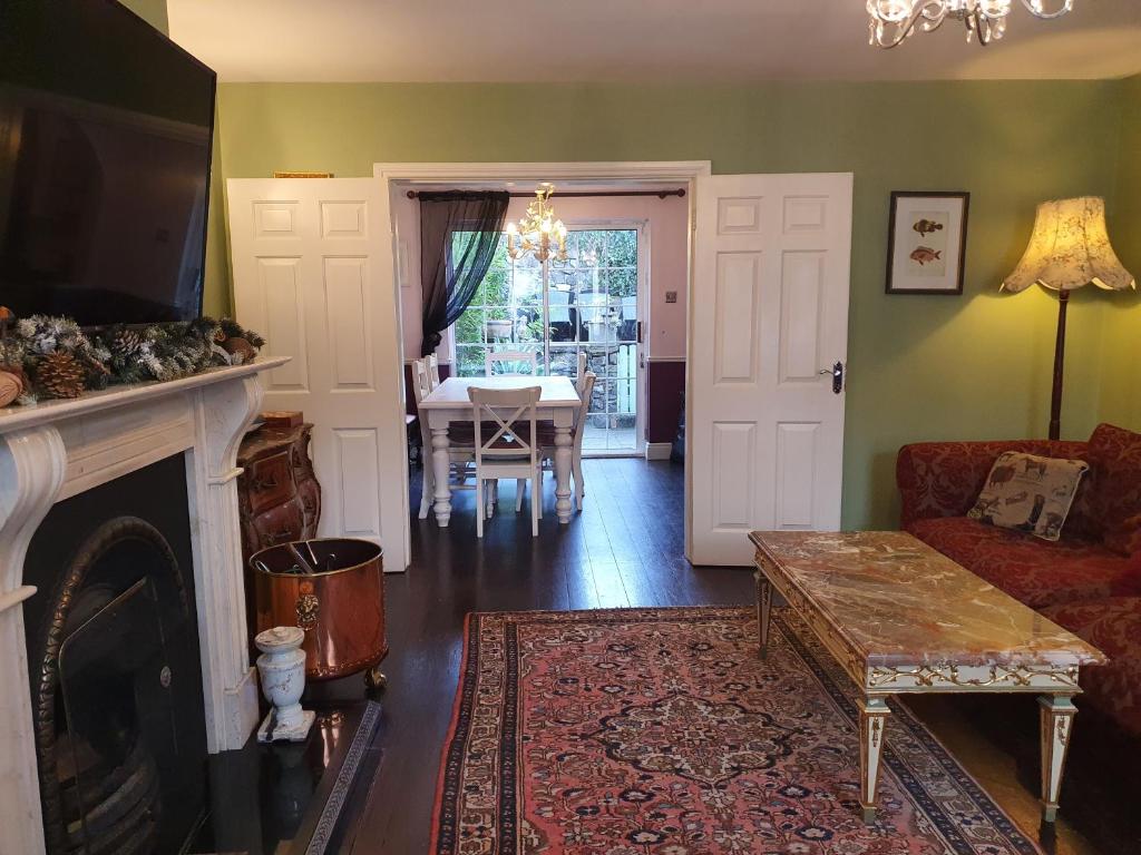 a living room with a couch and a fireplace at The Retreat in Carlingford