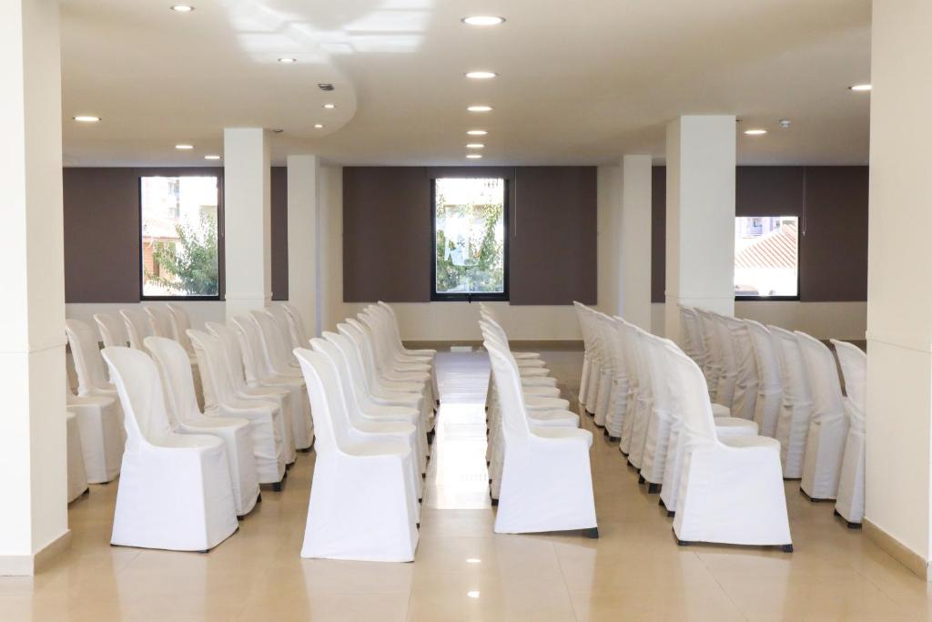 a row of white chairs in a waiting room at FAY Victoria Beach in Rincón de la Victoria
