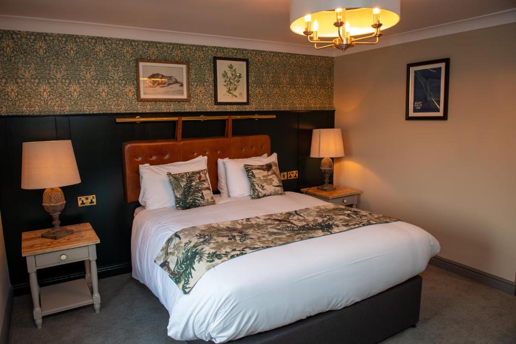 a bedroom with a large bed and two lamps at The Red Lion Inn by Chef & Brewer Collection in Todwick