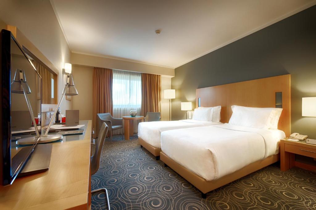 Säng eller sängar i ett rum på SANA Malhoa Hotel