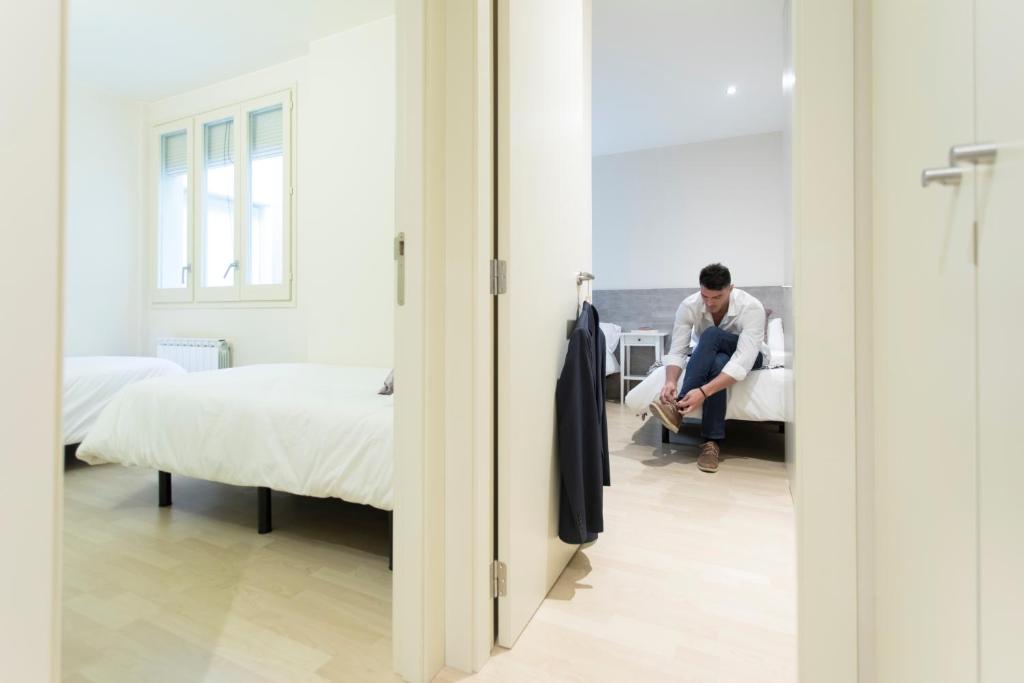 Postel nebo postele na pokoji v ubytování Bravissimo Cort Reial-3A