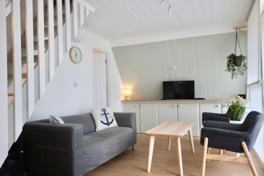 a living room with a couch and two chairs and a table at Kingsdown Chalet No.5 in Kingsdown