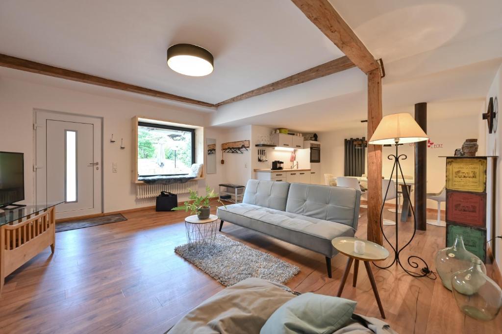 a living room with a couch and a table at Im Allgäuer Bauernstall in Nesselwang