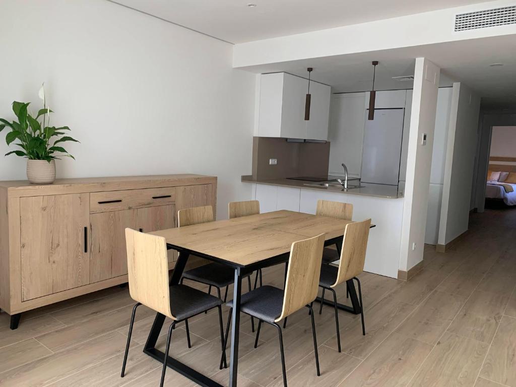 a kitchen and dining room with a wooden table and chairs at Ca La Rosalia Arbeca in Arbeca