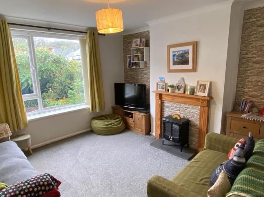 a living room with a couch and a television at Beautiful family home in Taffs Well