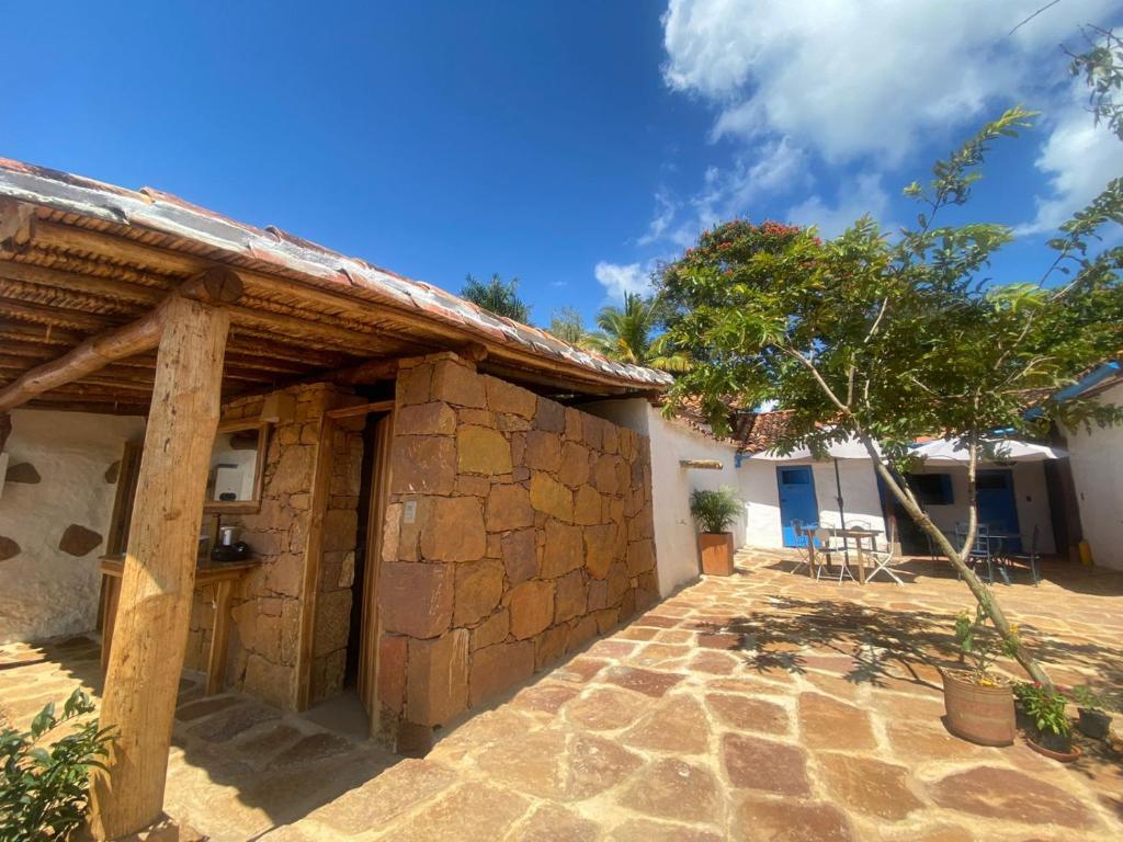 an outside view of a house with a stone wall at El Principito Hospedaje in Barichara