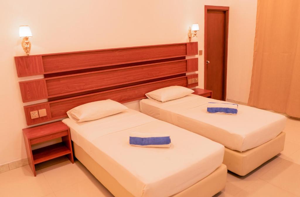 Postel nebo postele na pokoji v ubytování Feridhoo Inn