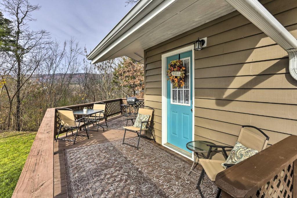 a deck with chairs and a blue door on a house at Picturesque Cottage in the Heart of Trenton! in Trenton