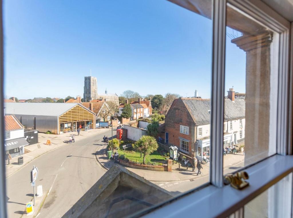 a view of a street from a window at High View, Southwold High Street (2 bed, 2 bath, allocated parking, balcony) in Southwold
