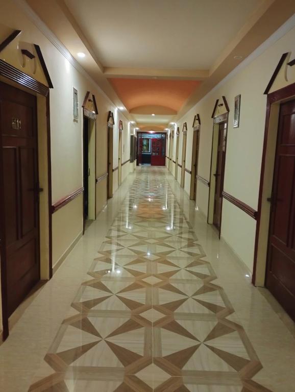 a hallway of a building with a tile floor at Hotel Mayfair in Lahore
