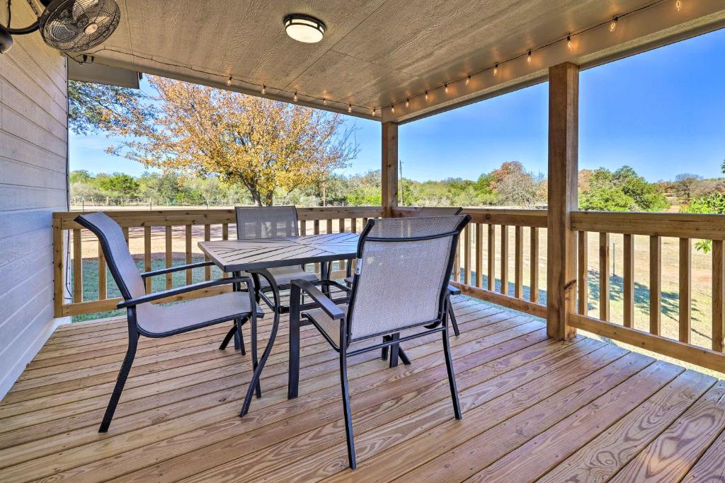 a porch with a table and chairs on a deck at Cozy Fredericksburg Studio Near Wineries! in Fredericksburg