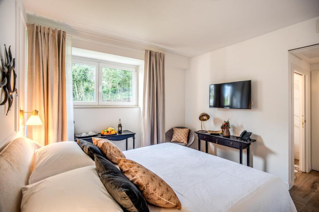 TV a/nebo společenská místnost v ubytování Vigna Caio Relais & Spa